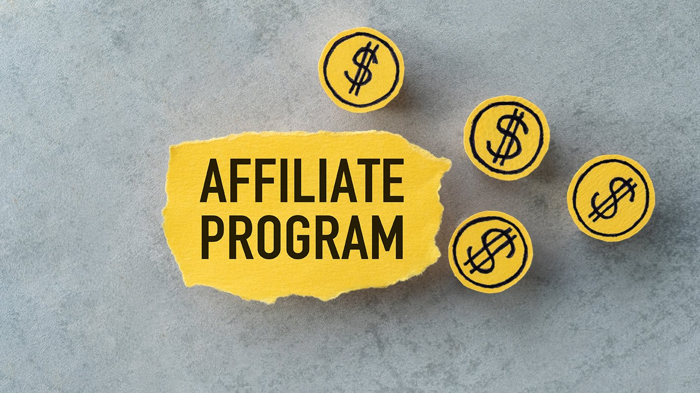 Affiliate program text on yellow paper with dollar sign coins, representing monetization strategies for podcasts.
