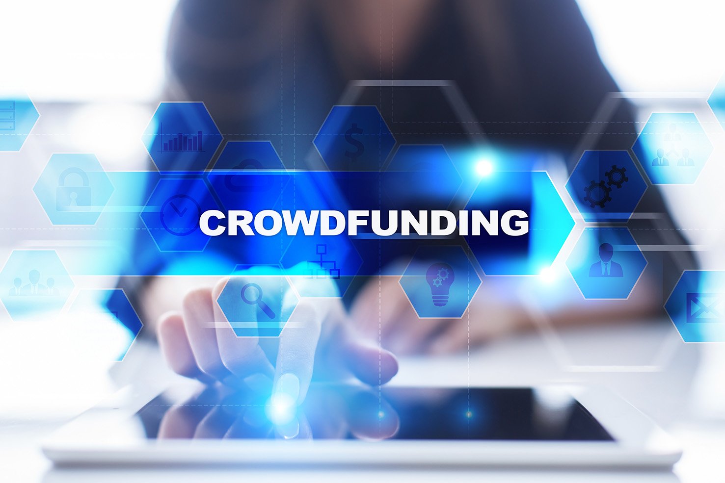 Crowdfunding concept image featuring the word "CROWDFUNDING" prominently displayed, with a hand touching a tablet and various icons representing financial support and community engagement.